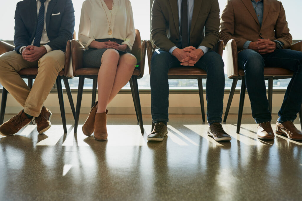 A row of job candidates await to interview for a property inspection company.
